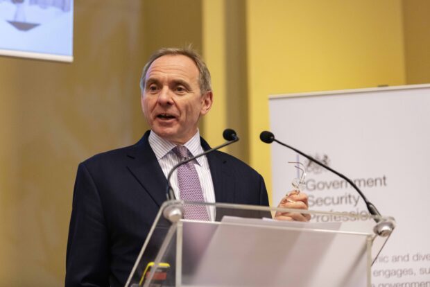 John Manzoni, Chief Executive of the Civil Service and Permanent Secretary for the Cabinet Office standing on the main stage delivering this keynote speech